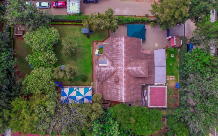 Aerial view of a tiled-roof building with gardens and parking in Karen, Nairobi